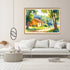 Framed painting of a landscape with a house on a wall above a white sofa.