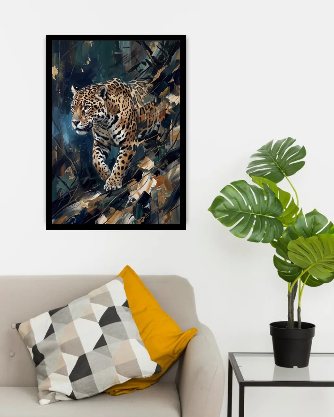 A framed art print of a leopard in a dark, textured background, displayed on a white wall above a beige sofa with decorative pillows and next to a potted monstera plant.