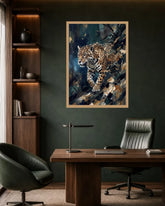 A framed vertical art print of a leopard in a dark, painterly style, displayed on a dark green wall above a wooden desk in a modern office setting.