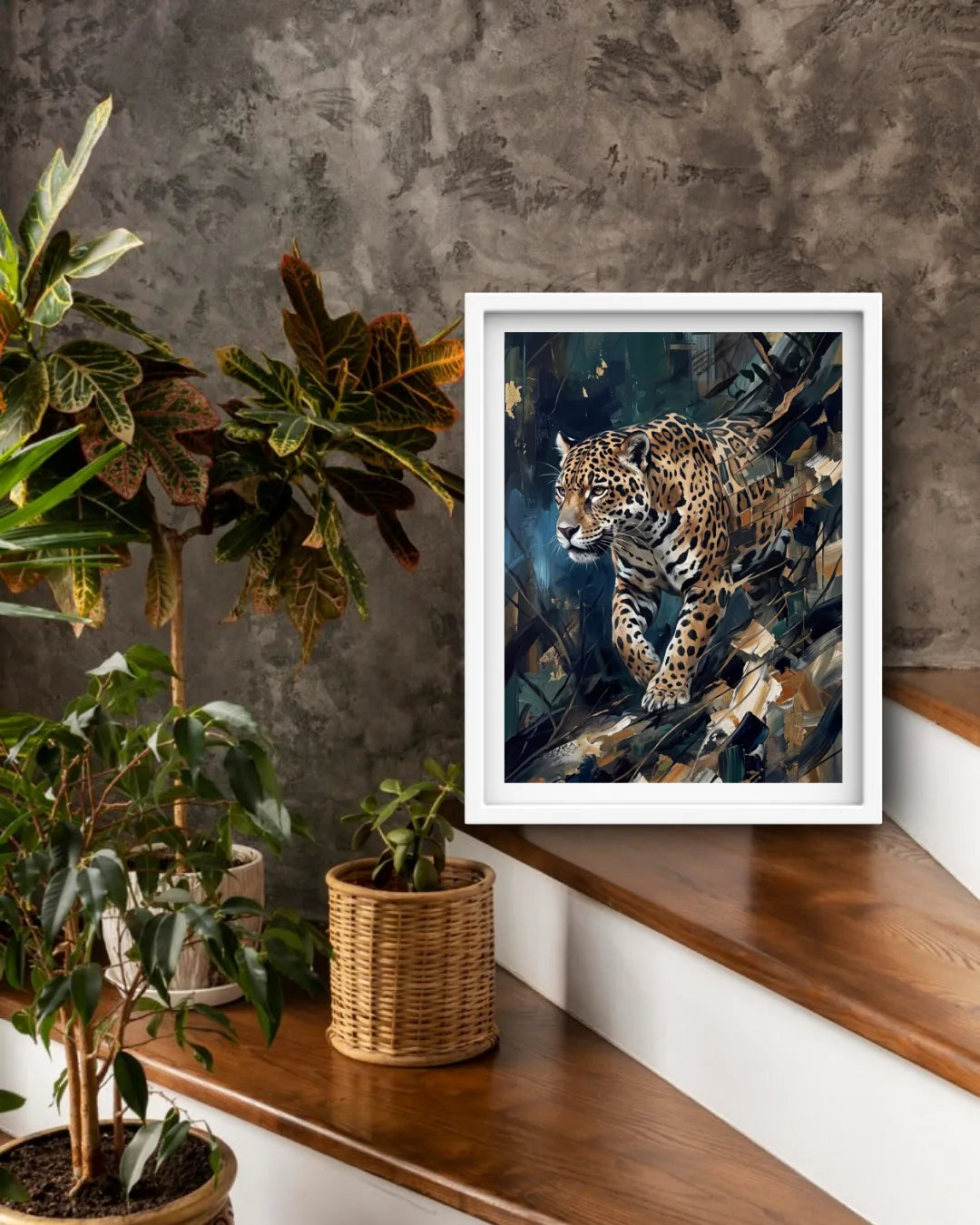 A framed art print of a leopard in a jungle scene, displayed on a wooden staircase landing next to potted plants against a textured gray wall.
