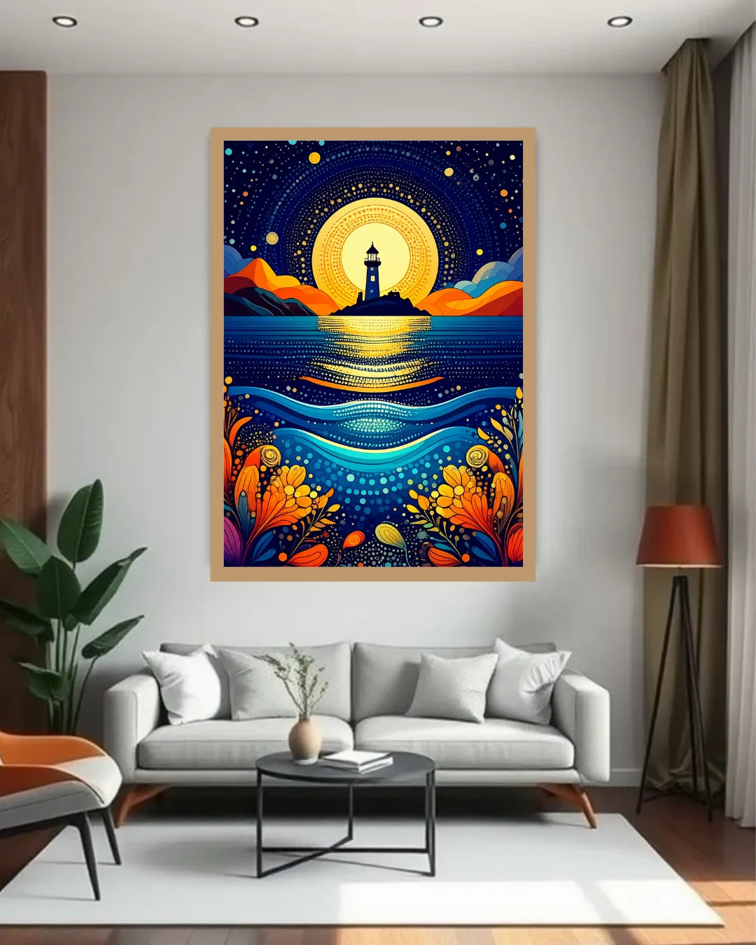 A framed vertical art print featuring a stylized lighthouse at night over blue water, displayed on a wall above a modern gray sofa in a living room setting.