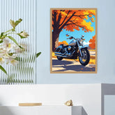 A framed art print depicting a blue cruiser motorcycle under a vibrant orange autumn tree, displayed on a light blue wall above a white console table.