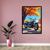 A framed art print featuring a stylized blue motorcycle under an orange autumn tree, displayed on a dusty pink wall in a room setting with a potted plant and vases.