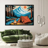 A framed art print depicting a mountain camping scene with an orange tent, campfire, river, and pine trees, displayed on a beige wall above a green velvet sofa in a modern living room setting.