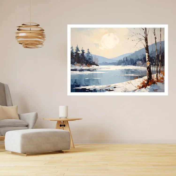 A framed landscape art print depicting a snowy lakeside scene with trees and mountains under a pale moon, displayed on a beige wall in a modern living room setting.