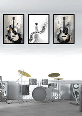 Black and white guitar and piano canvas wall art set displayed above a drum kit in a modern music studio.