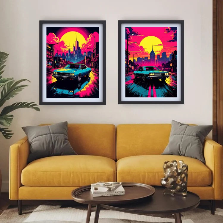 Two framed retro cyberpunk-style art prints hang above a mustard yellow sofa in a modern living room. Each print shows a neon city street scene with a blue car, pink and yellow sun, and dark skyline.