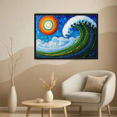 A framed abstract ocean wave artwork hangs on a beige wall above a light gray armchair, with a small round table and vases in the room. The artwork features a bright sun and a large curling wave made of dotted colors including blue, green, yellow, and white.