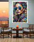 Colorful abstract portrait of a woman with sunglasses on a wall in a dining room.