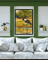 Framed artwork of a bird on a wall above a sofa with decorative pillows.
