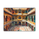 A rectangular wall art print showing an ornate courtyard with multi-story balconies, arches, and patterned flooring in warm orange, gold, teal, and brown tones, photographed against a plain white background.
