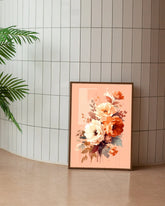Peach floral wall art canvas displayed on the floor against a tiled wall
