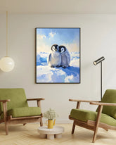Living room with green armchairs, a small table, and a framed picture of penguins on the wall.