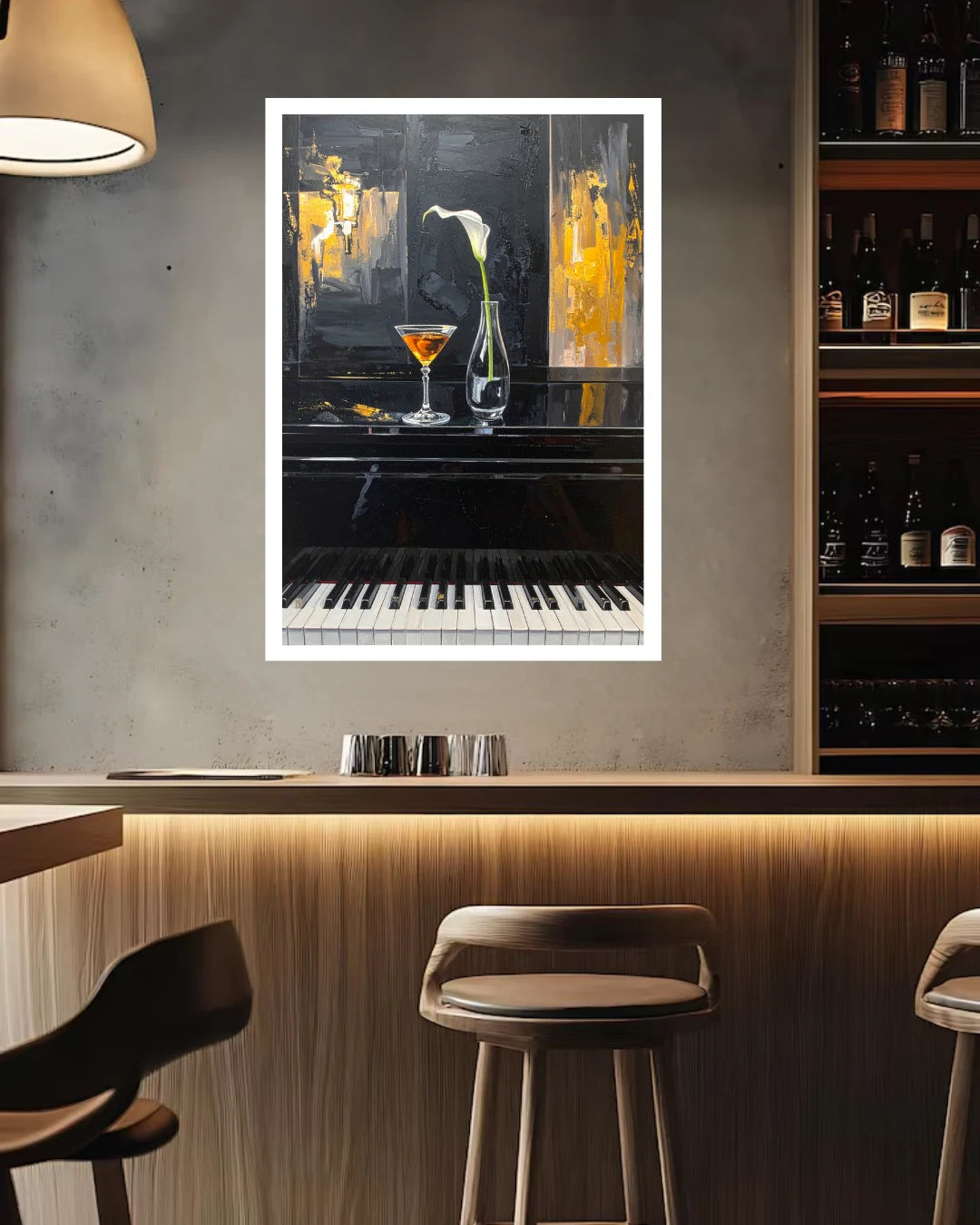 A framed vertical art print depicting a piano with a martini glass and a white lily flower, displayed on a gray concrete wall in a modern bar setting with wooden stools and shelves.
