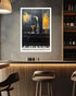 A framed vertical art print depicting a piano with a martini glass and a white lily flower, displayed on a gray concrete wall in a modern bar setting with wooden stools and shelves.