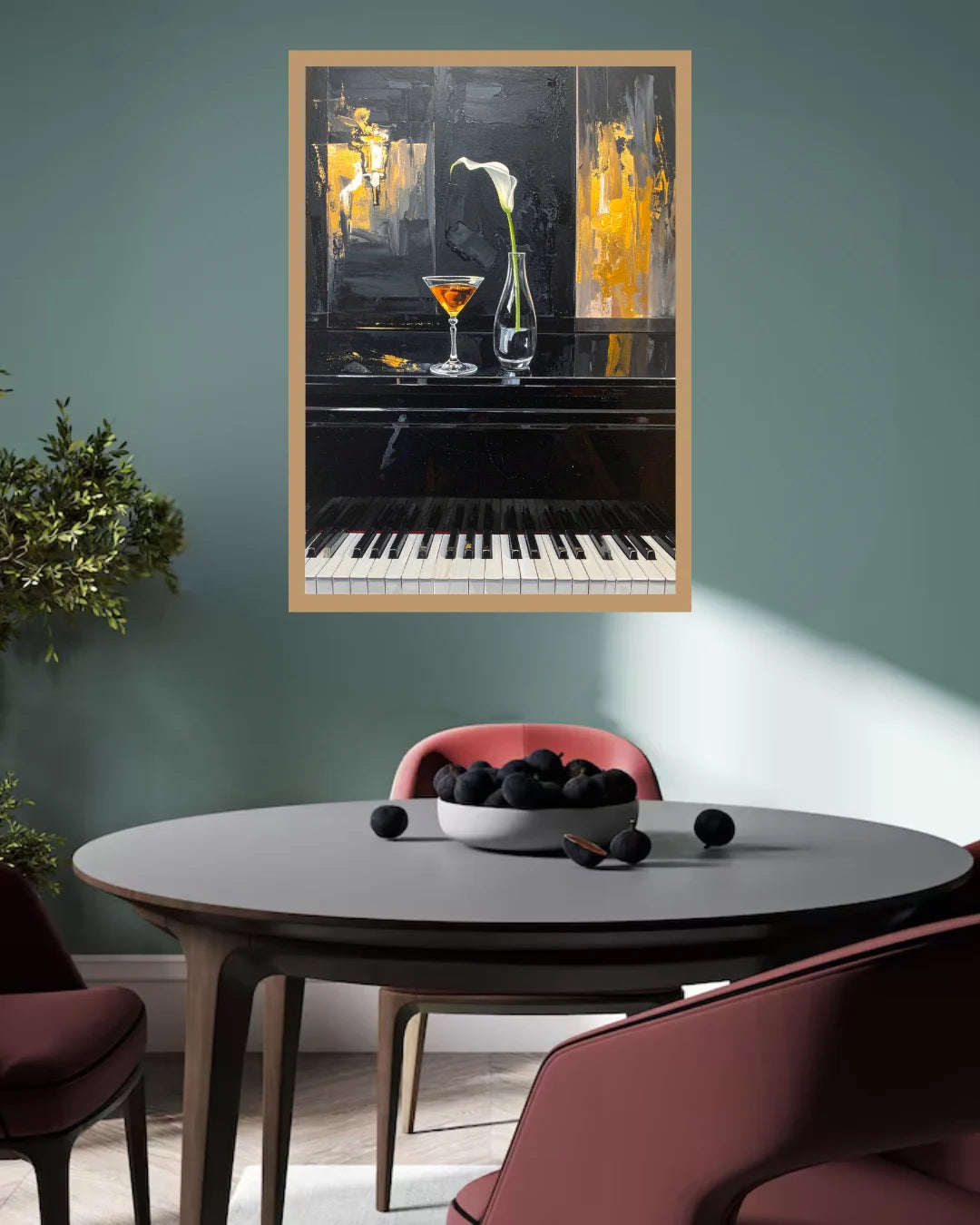 A framed abstract painting of a piano and cocktail glasses hangs on a teal wall above a round dining table with chairs and a bowl of dark fruit.