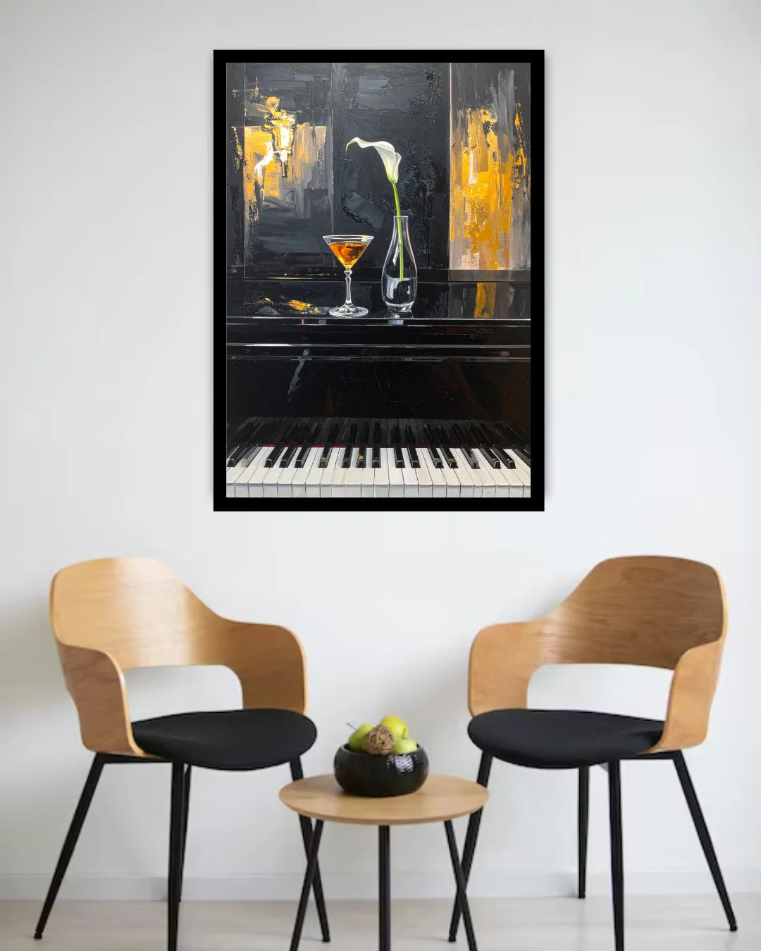 A framed wall art print depicting a piano with a cocktail glass and a white lily, displayed in a modern living room setting above two wooden chairs and a small round table.