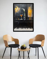 A framed wall art print depicting a piano with a cocktail glass and a white lily, displayed in a modern living room setting above two wooden chairs and a small round table.