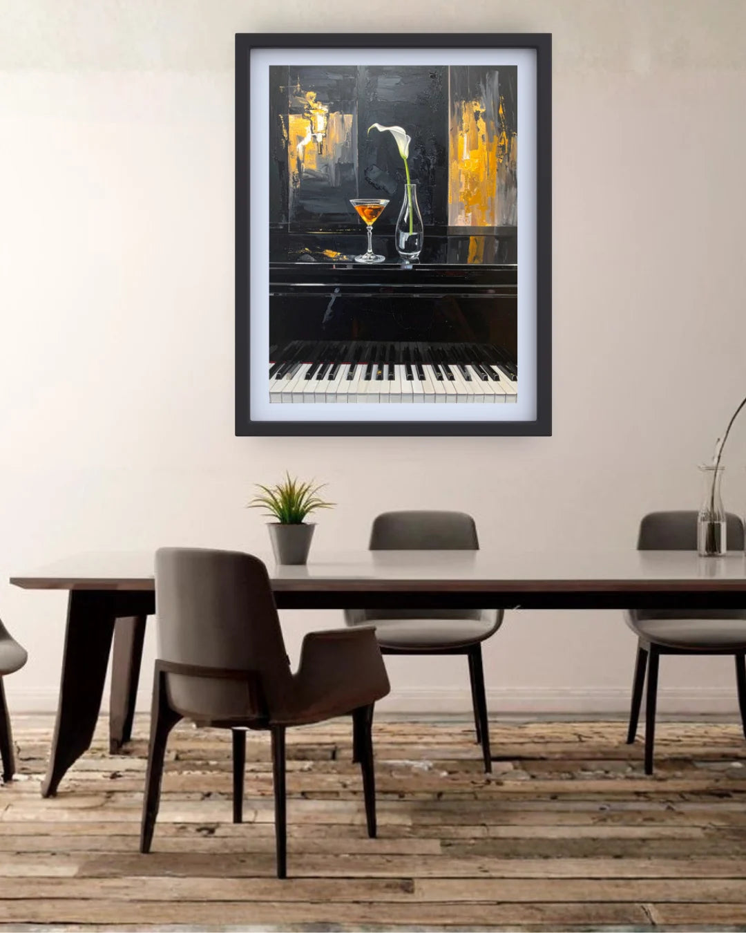 A framed abstract art print depicting a piano, cocktail glass, and flowers, displayed on a beige wall above a dining table with chairs in a modern room setting.