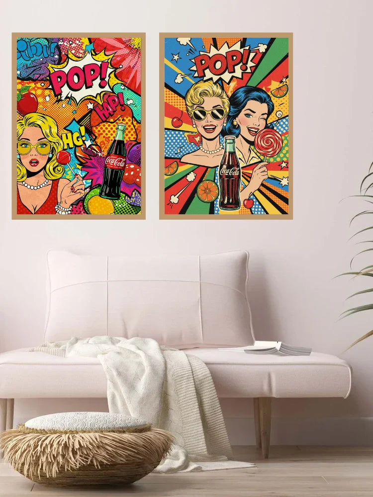 Two framed pop-art posters featuring retro women and Coca-Cola bottles, displayed above a light pink sofa in a modern living room setting.
