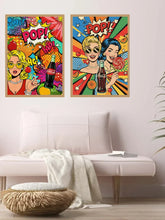 Two framed pop-art posters featuring retro women and Coca-Cola bottles, displayed above a light pink sofa in a modern living room setting.