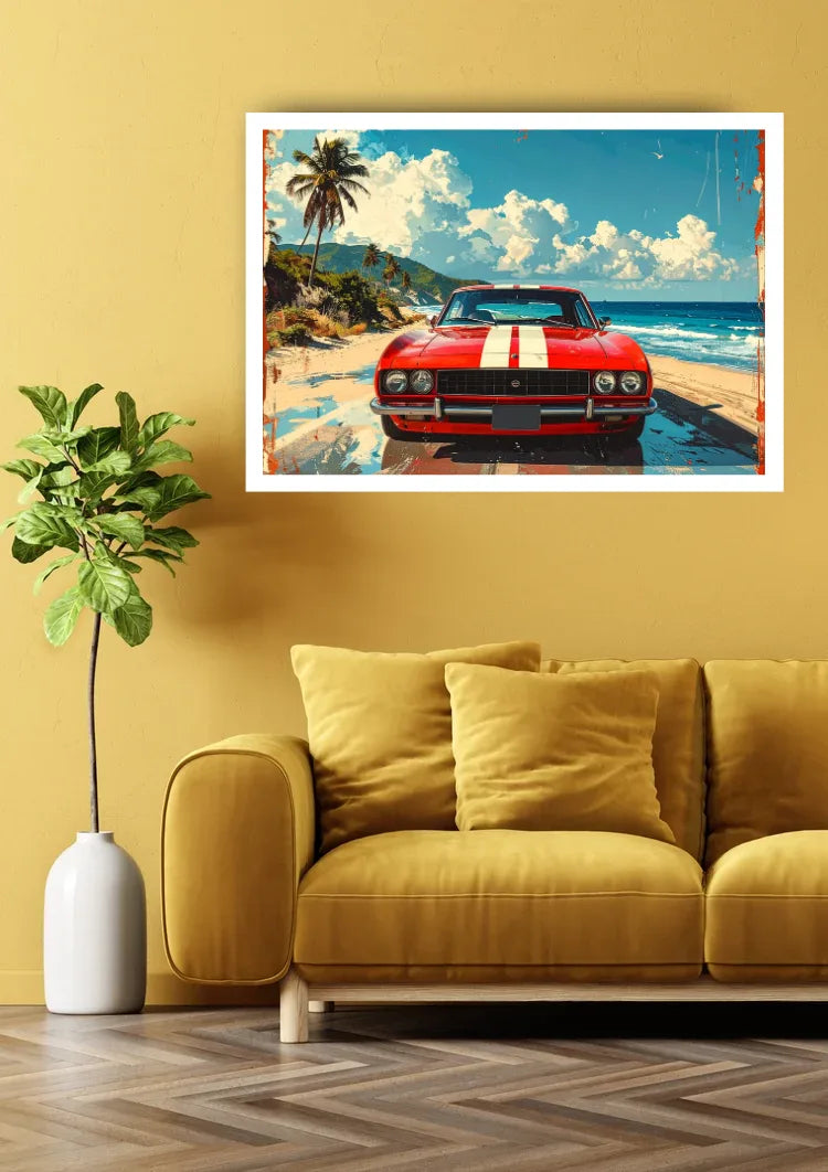 A framed wall art print showing a red classic car on a tropical beach, displayed above a mustard yellow sofa in a styled living room setting.