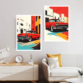 Two framed art prints featuring retro red classic cars in an urban street scene, displayed on a light gray wall above a modern white sofa with yellow and white pillows in a styled living room.