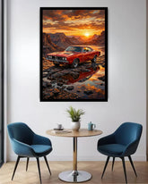 A framed vertical art print depicting a red muscle car parked on a rocky shore at sunset, displayed on a white wall above a small round table with two blue chairs in a modern room.