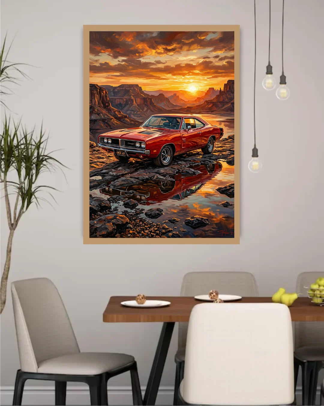 A framed wall art print depicting a red classic muscle car parked in a rocky desert landscape at sunset, displayed above a dining table in a modern room setting.