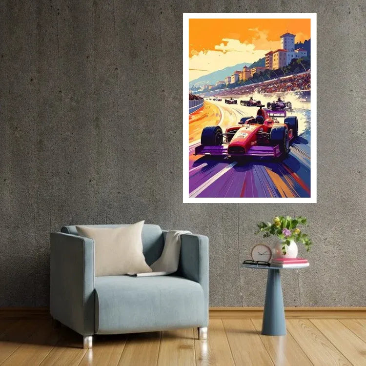 A framed art print of a vibrant Formula 1 race in Monaco, featuring red race cars on a purple track under an orange sky, displayed on a textured gray wall above a light blue armchair and a small side table.