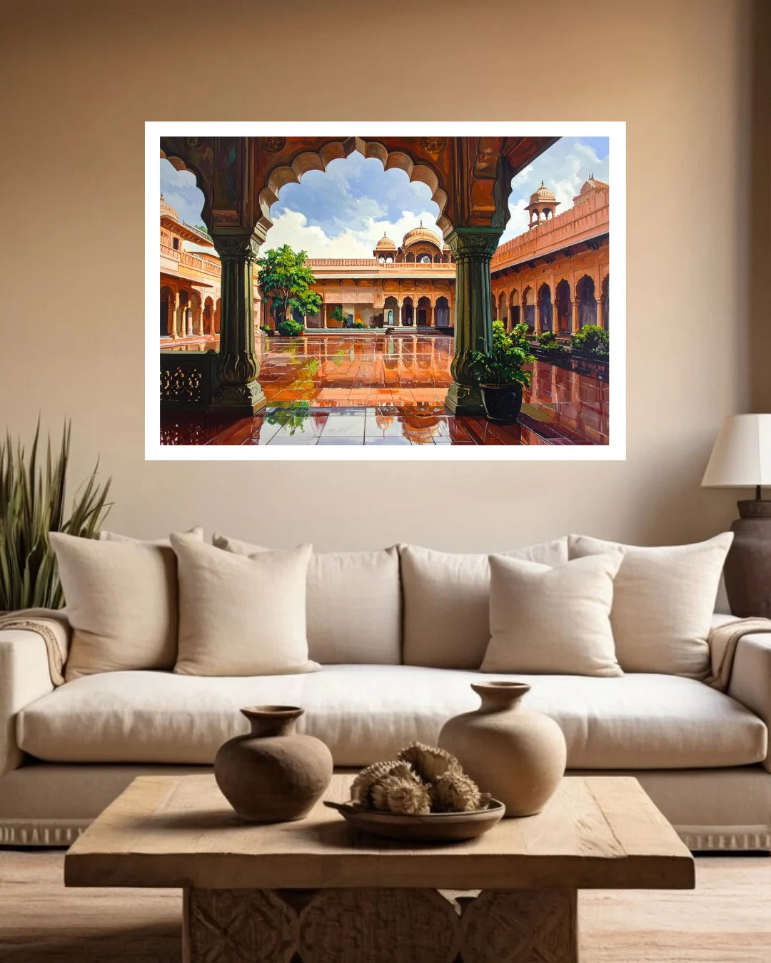 A framed art print depicting a vibrant courtyard scene with arches and domes, displayed on a beige wall above a modern white sofa in a living room setting.