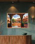 A framed painting of a traditional Indian courtyard with arches and a reflective pool, displayed on a textured teal wall above a wooden console table.