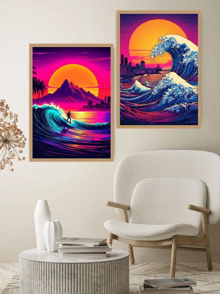 Two framed retro-style wall art prints hang above a white armchair in a modern living room. The left print shows a surfer riding a neon wave at sunset, and the right print shows a large wave cresting over a city skyline under a glowing sun.