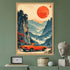 A framed art print featuring a retro orange convertible car driving through a misty mountain landscape under a large red sun, displayed on a green wall above a shelf with decorative objects.