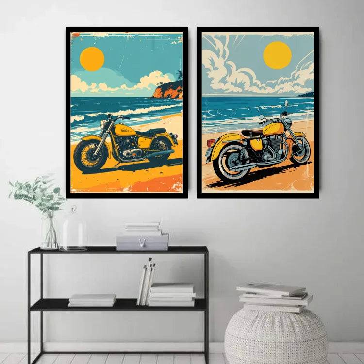 Two framed vertical art prints depicting retro yellow motorcycles on a beach, displayed side-by-side on a light gray wall above a black metal shelf with books and decor.