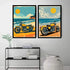 Two framed vertical art prints depicting retro yellow motorcycles on a beach, displayed side-by-side on a light gray wall above a black metal shelf with books and decor.