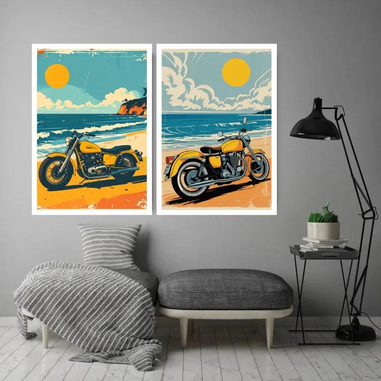 A pair of framed wall art prints featuring retro-style yellow motorcycles on beach scenes, displayed above a bench in a styled living room with a gray wall, black floor lamp, and small side table.
