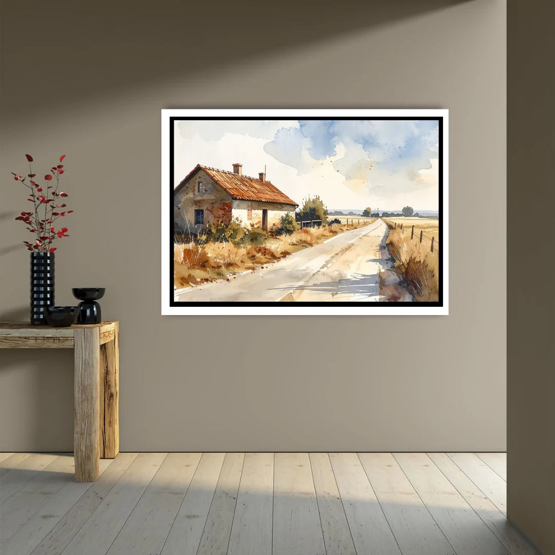 Framed painting of a rural landscape with a house on a wall in a room.