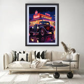 A framed wall art print depicting a neon-lit vintage car in front of a diner at night, displayed above a beige sofa in a modern living room setting.