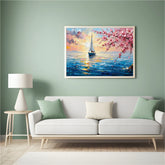 Framed artwork of a sailboat and cherry blossoms above a white sofa in a living room.