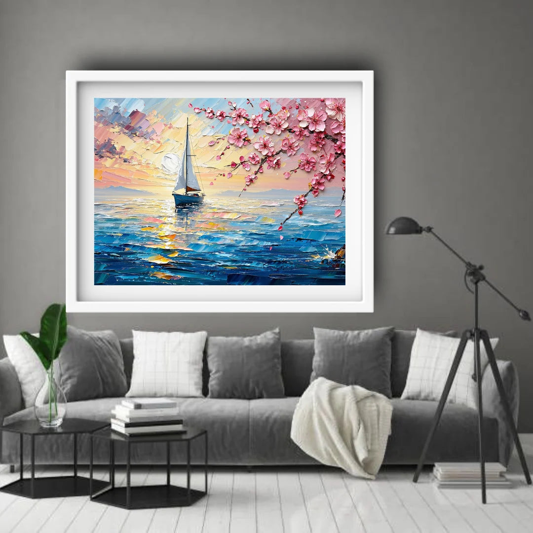 Framed painting of a sailboat and cherry blossoms above a gray sofa in a living room.