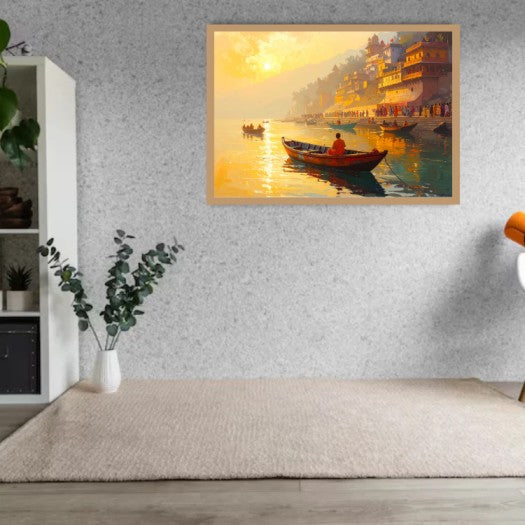 A framed art print depicting a scenic sunset over a river with boats and illuminated ghats, displayed on a textured gray wall above a beige rug in a modern room setting.
