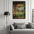 A framed vertical art print depicting a serene courtyard pond with lily pads and pink lotus flowers, hung on a white paneled wall above a gray sofa in a modern living room setting.