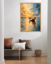 A framed vertical canvas print of a sunset boat painting hanging on a white wall above a wooden bench with decorative pillows in a modern living room setting.