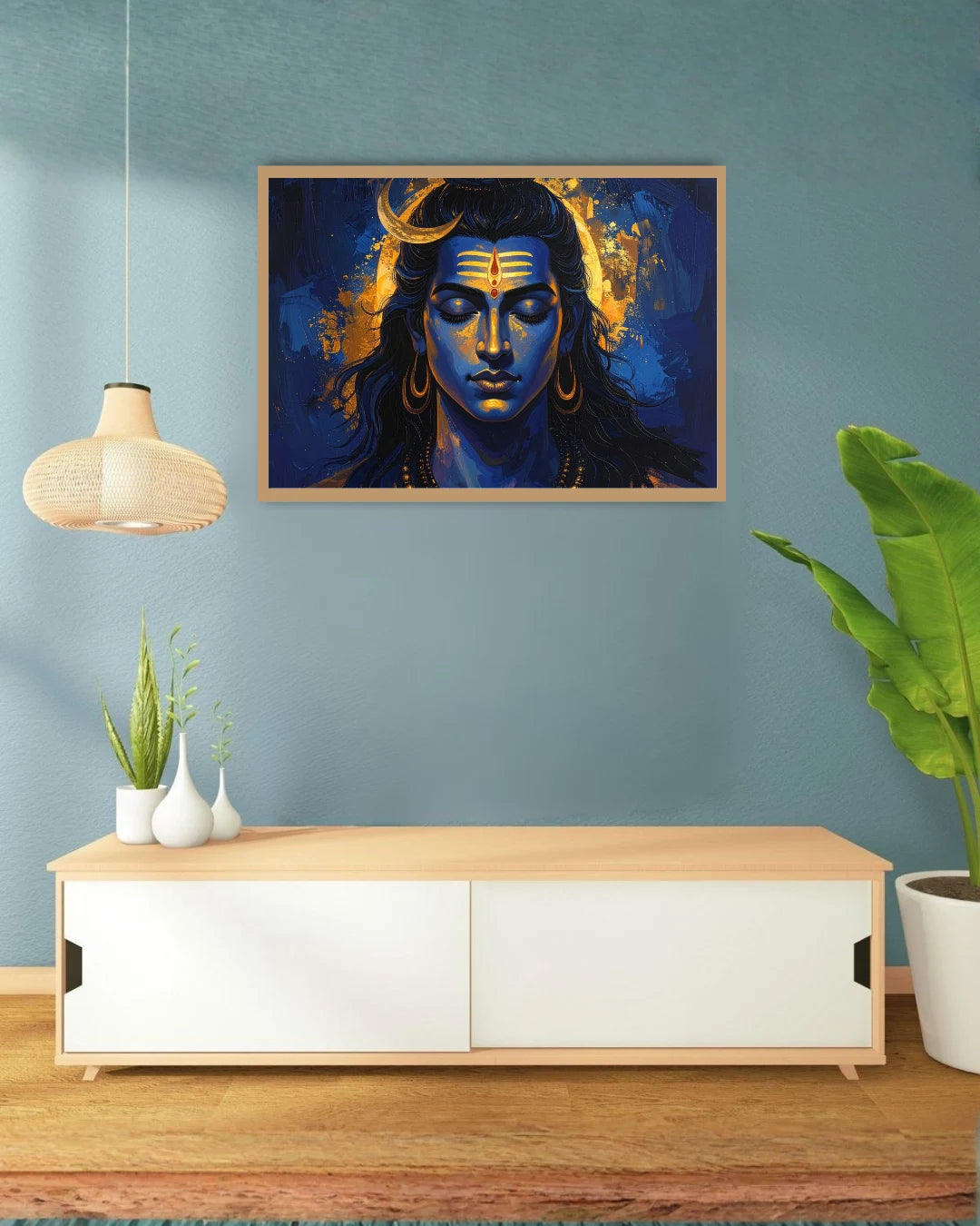 Framed artwork of a stylized face on a wall above a wooden cabinet with decorative items.