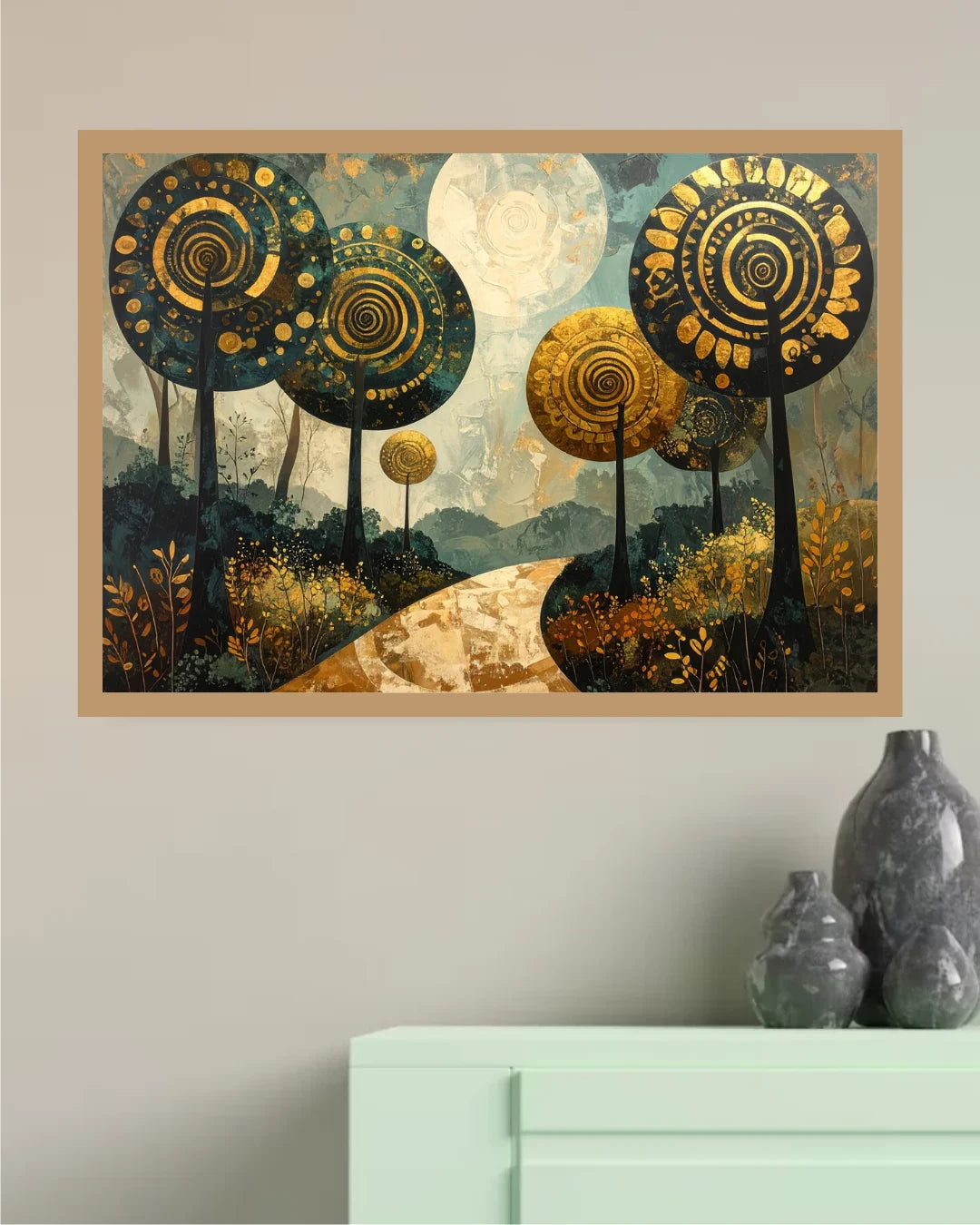 A framed wall art print depicting stylized trees with spiral patterns in gold, beige, and dark blue tones, displayed on a light gray wall above a mint green cabinet with gray decorative vases.
