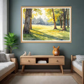 Framed landscape painting on a wall above a wooden console table in a living room.