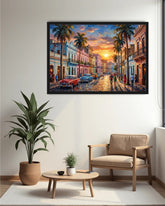 A framed colorful painting of a vintage street scene in Havana hangs on a white wall above a beige armchair, a small wooden coffee table with a plant, and a large potted plant.