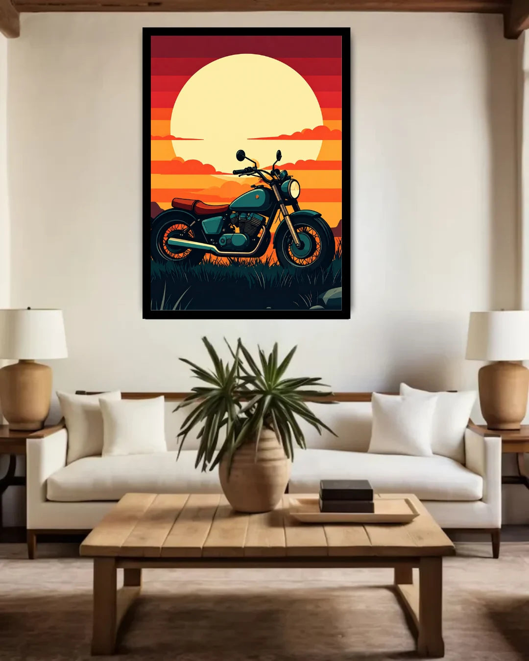 A framed vertical art print featuring a teal motorcycle against a vibrant orange and yellow sunset, displayed on a beige wall above a modern white sofa in a styled living room.