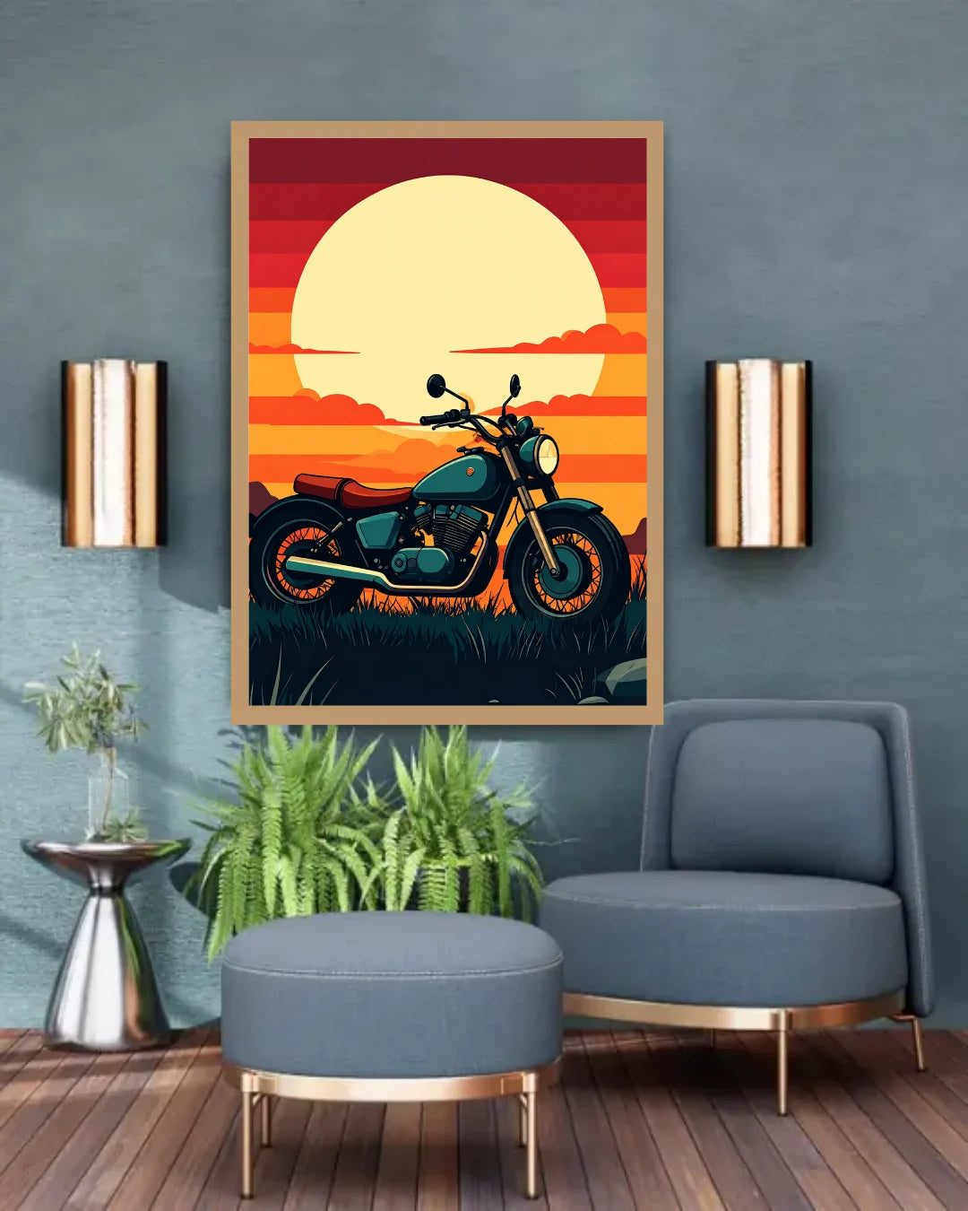 A framed vertical art print featuring a retro motorcycle against a vibrant orange and yellow sunset, displayed on a textured blue-gray wall in a modern living room setting with a blue armchair, ottoman, and wall sconces.
